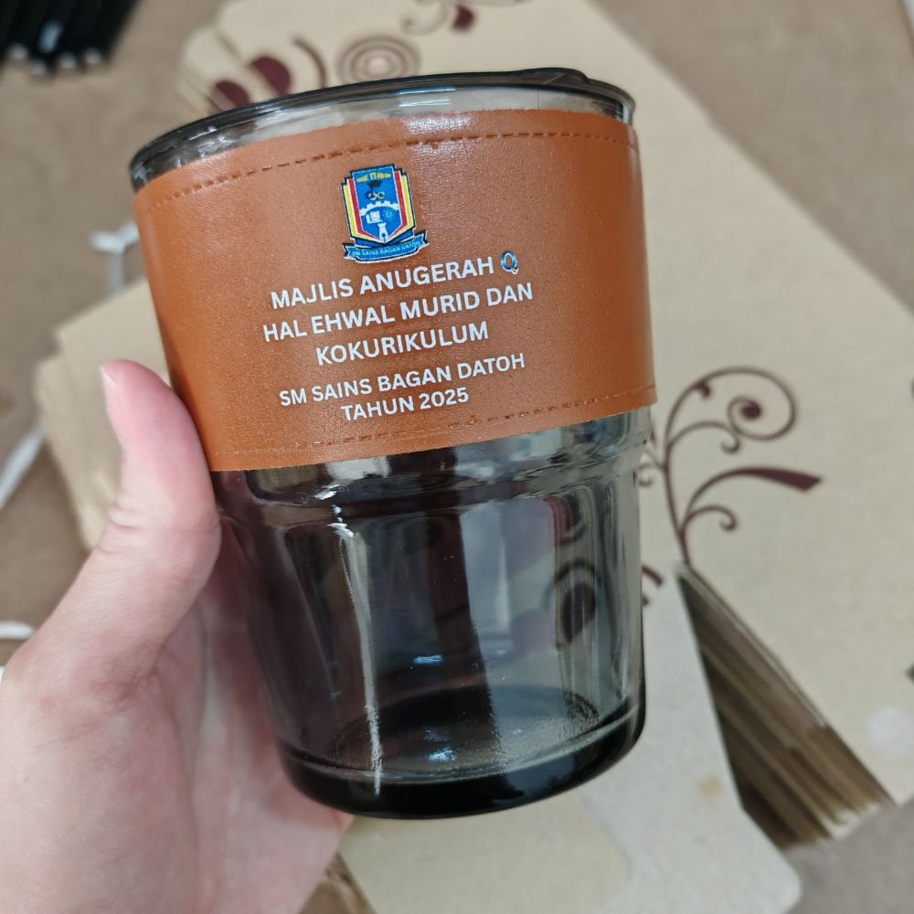 Custom glass mug with company logo and protective sleeve for corporate gifts